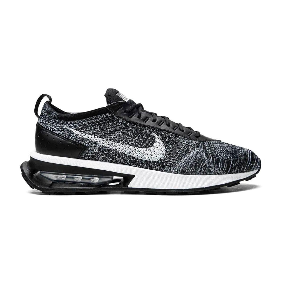 Black and white Nike Air Max Flyknit Racer sneaker with replacement laces.