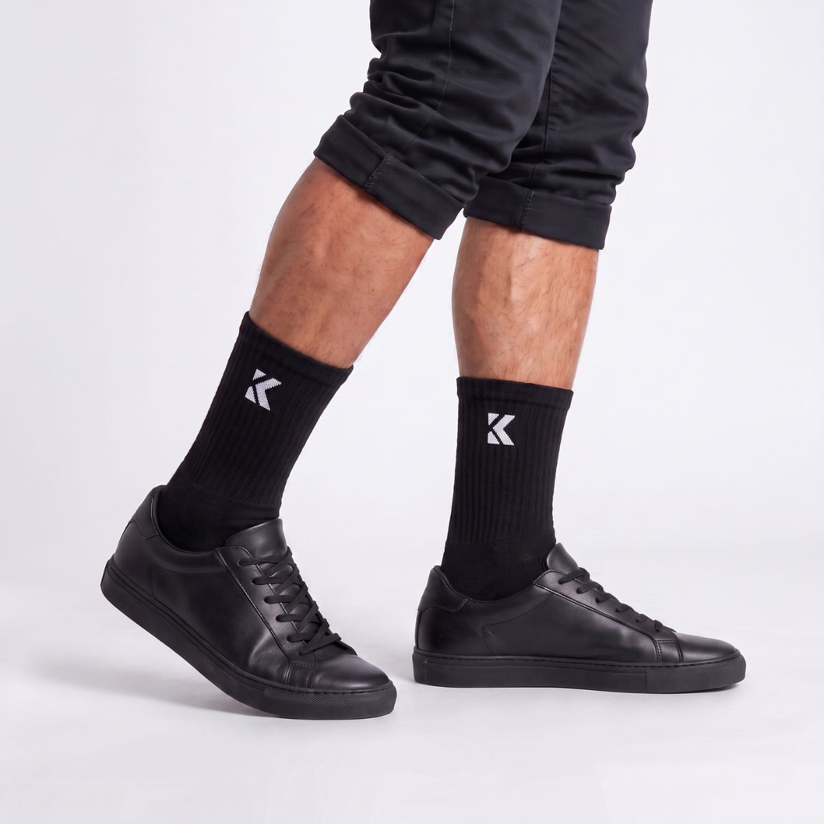 Model wearing black crew socks shown from the side, highlighting the crew length and comfortable fit.