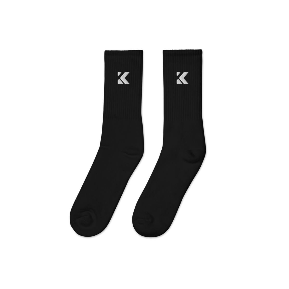 Pair of black socks with a kicks logo on a white background