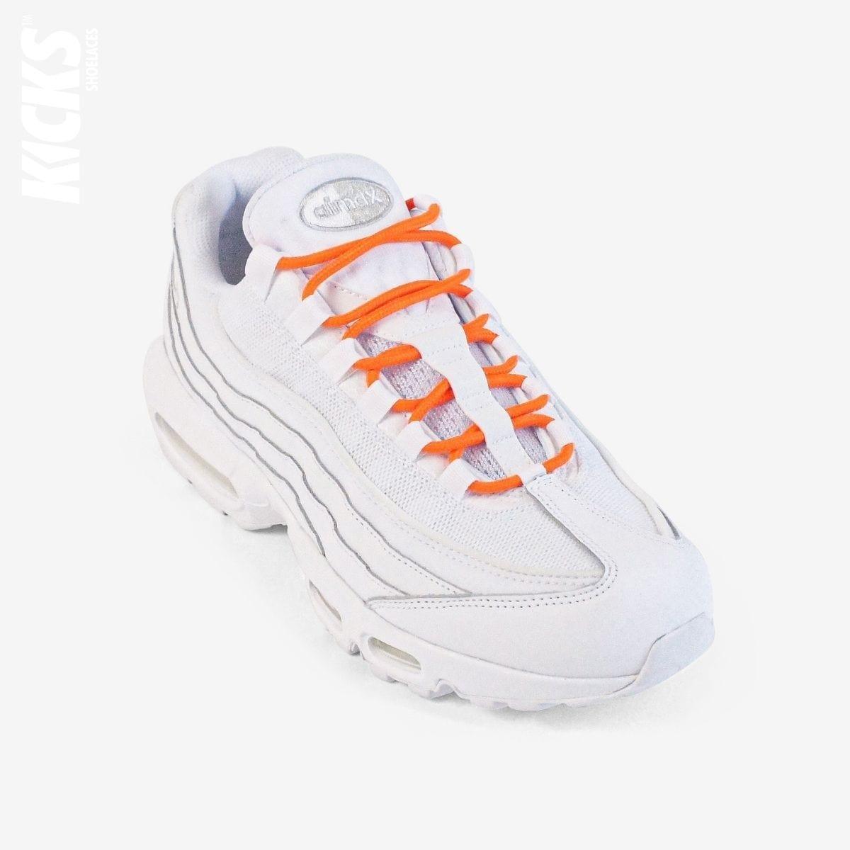 Orange round shoestrings on white sneakers by Kicks Shoelaces