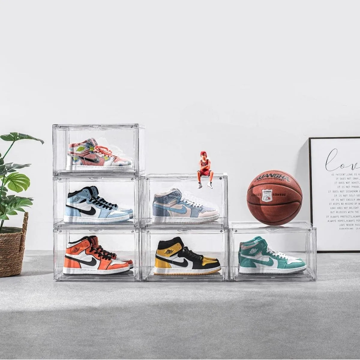 Six clear stackable shoe display boxes showcasing sneakers in a modern lifestyle setting.