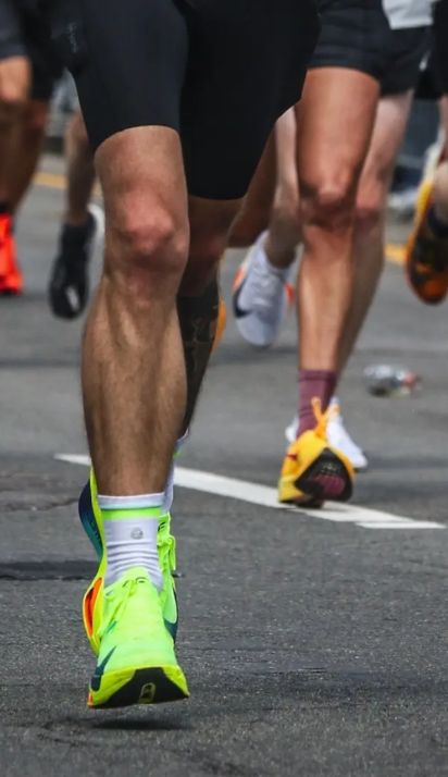 Close-up of running shoes with bright green running laces.