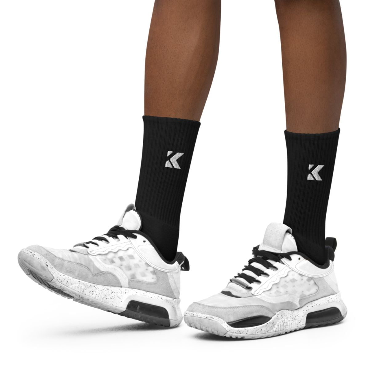 White sneakers worn with black socks 