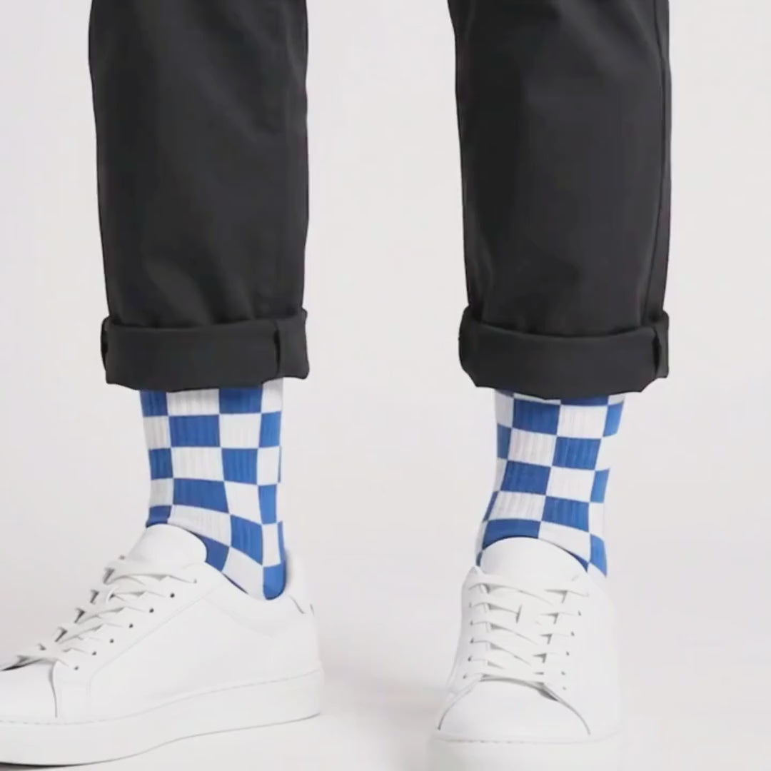 Video showing the Kicks Checkered Crew Socks 3-Pack in blue and white, red and white, and black and white colourways worn with white sneakers in a studio.