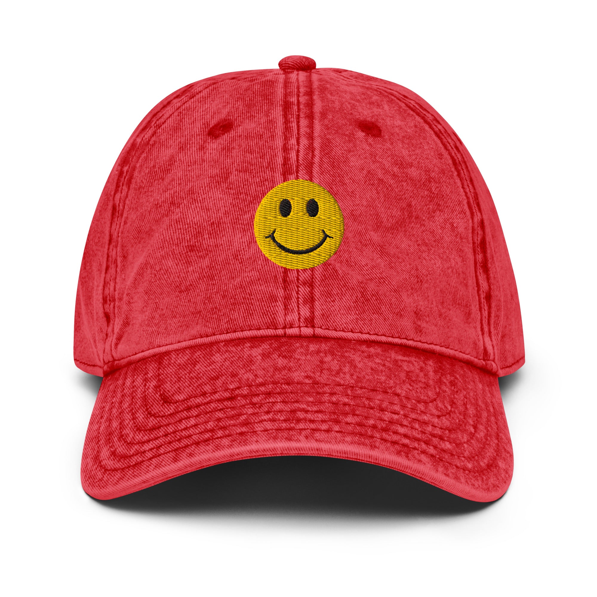 Red smiley face embroidered baseball cap with adjustable fit, washed-out design for everyday wear and street style.