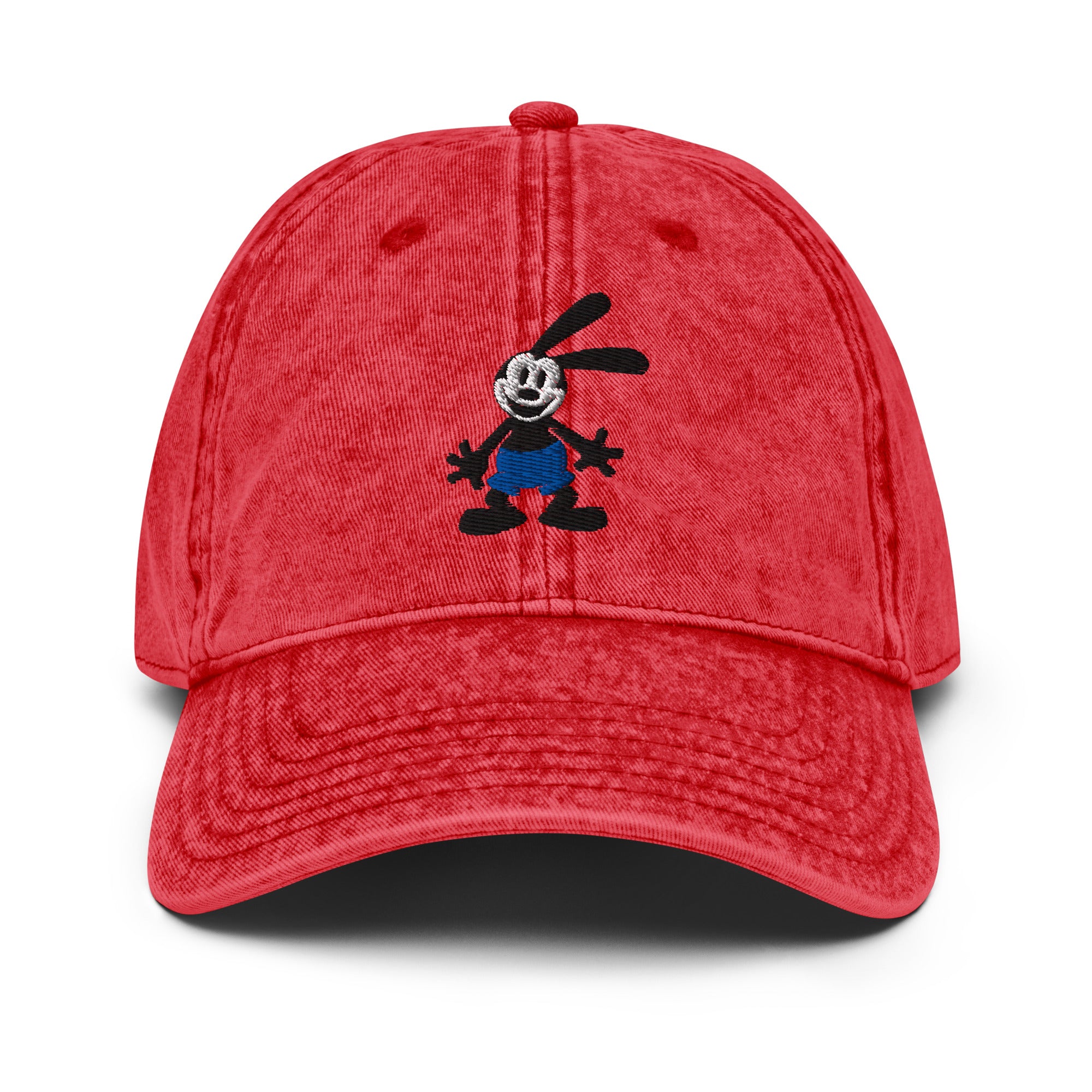 Red vintage cap featuring a 1928 Oswald design from Disney’s early animation era on a washed-out hat